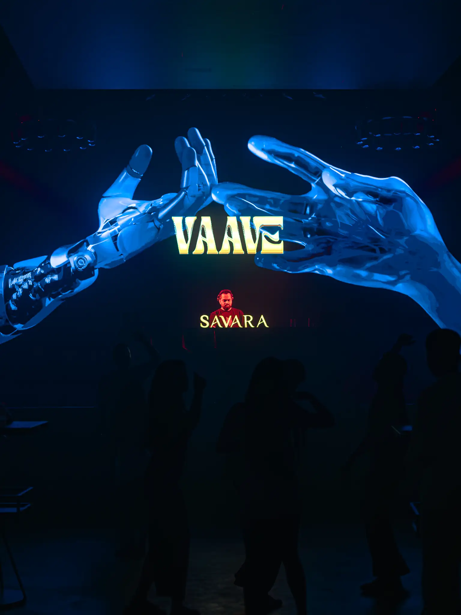 VAAVE and Savara logos on the main LED wall between two chrome hands